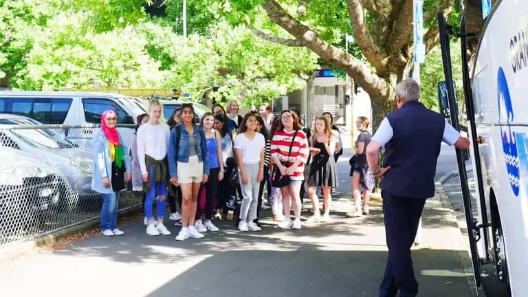 A group of She Sharp attendees standing together outdoors under trees during the Auckland Tech Grand Tour.