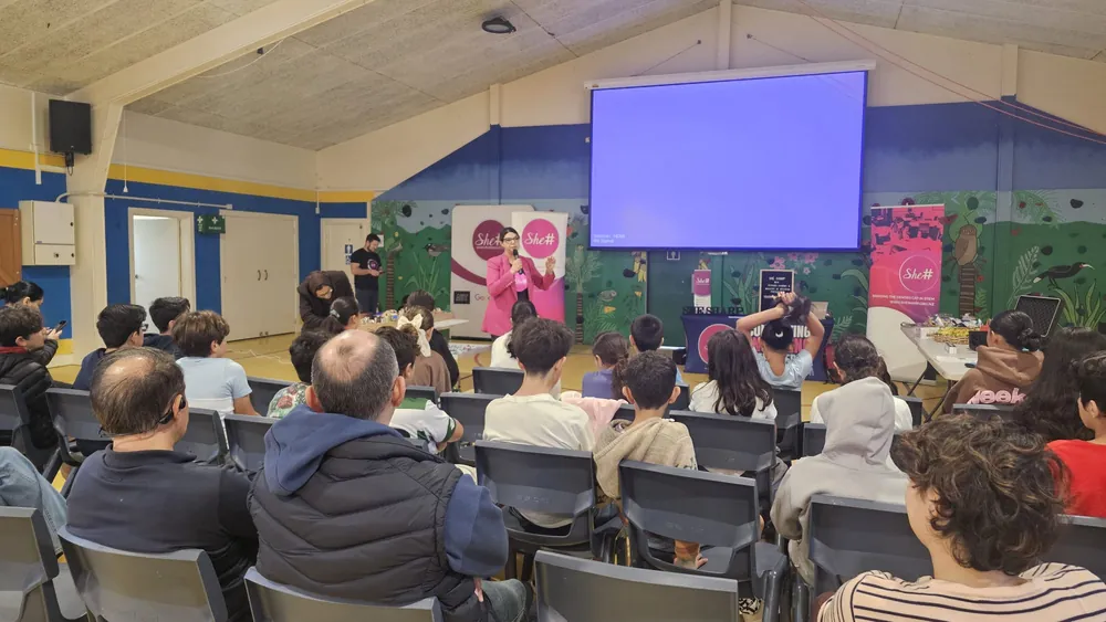 Young participants seated in the school hall watching the AI & Electronics Workshop presentation