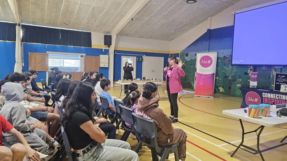 A SheSharp facilitator presenting AI concepts to youth participants at Fruitvale Primary School