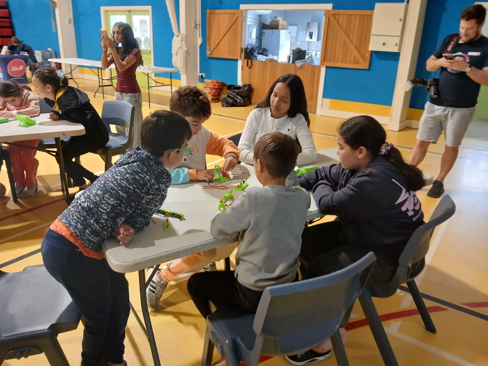 A SheSharp facilitator guiding young participants through a hands-on electronics activity