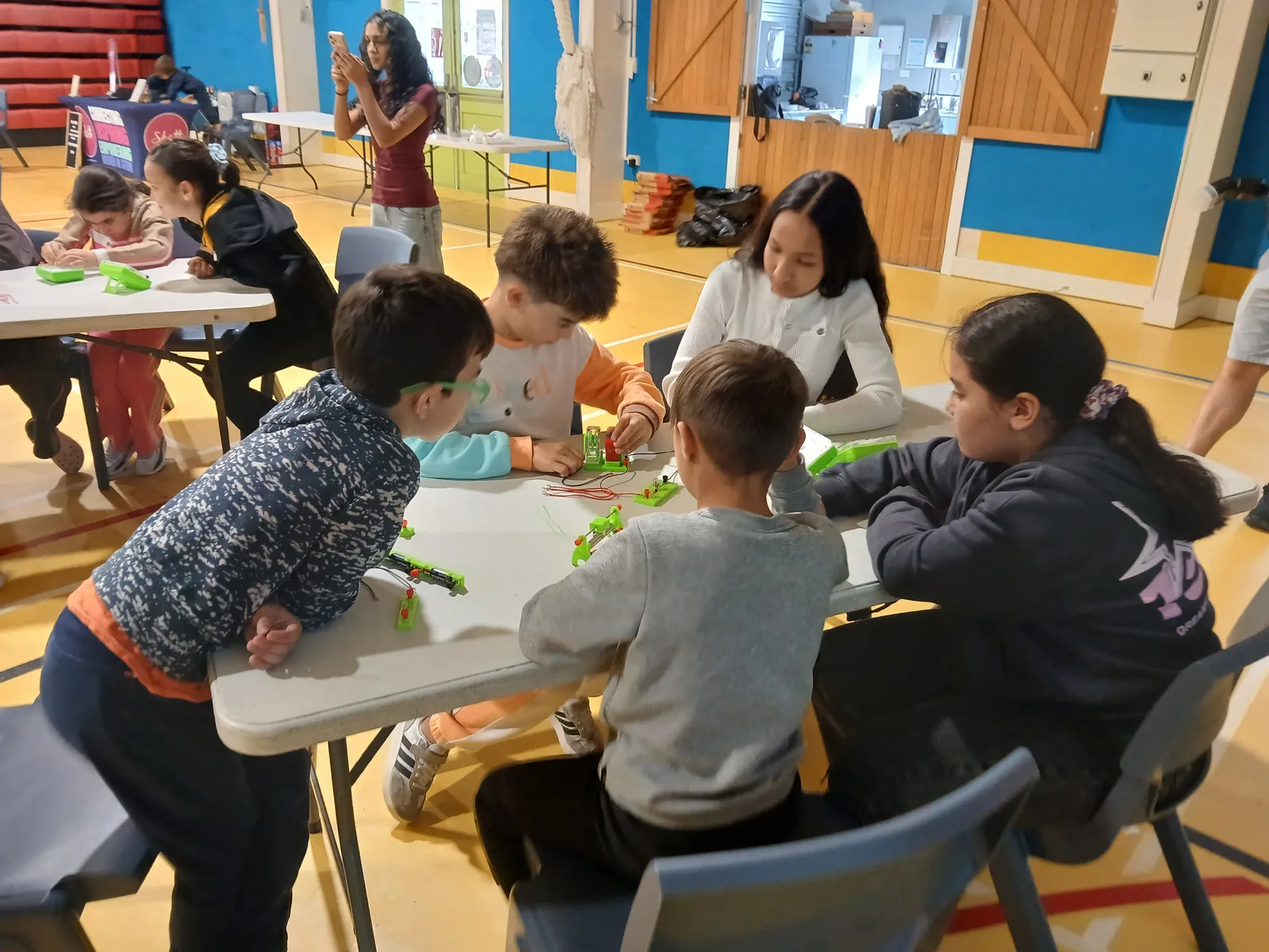 Young participants working together on an electronics activity at the workshop
