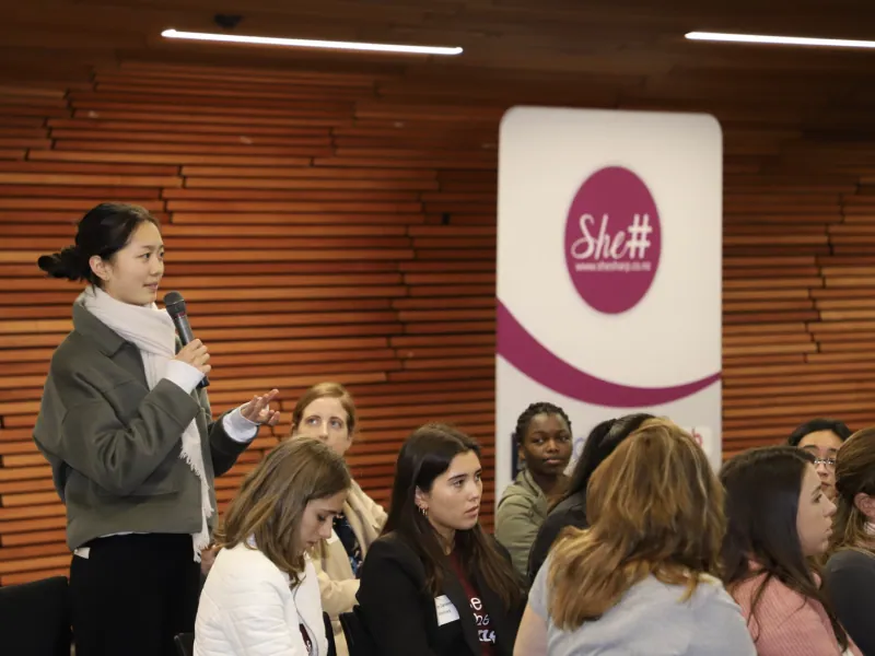 Lady speaking in an audience